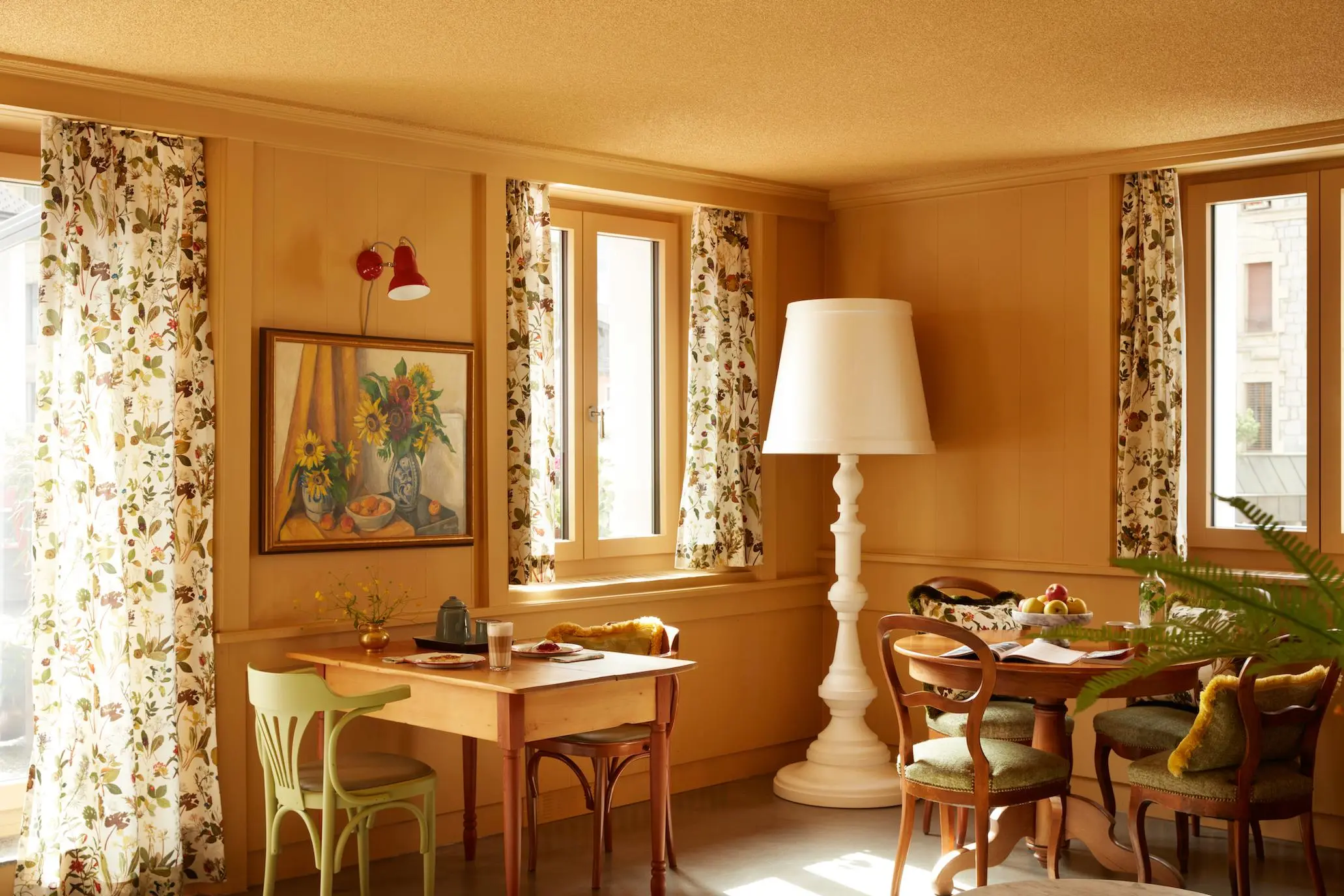 Hotel lounge with House of Hackney curtains, vintage furniture and an oversized white Moooi designer lamp